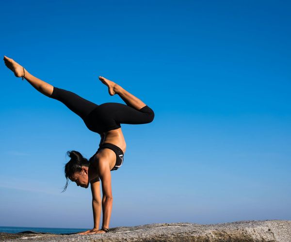 Person demonstrating a yoga pose that requires strength and focus.